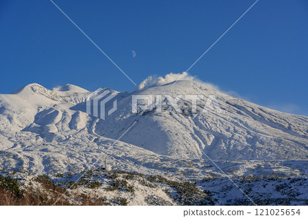 Hokkaido: Snow-capped Mount Asahidake and the moon in winter Hokkaido: Snow-capped Mount Asahidake and the moon in winter 121025654