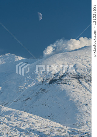 Hokkaido: Snow-capped Mount Asahidake and the moon in winter Hokkaido: Snow-capped Mount Asahidake and the moon in winter 121025655