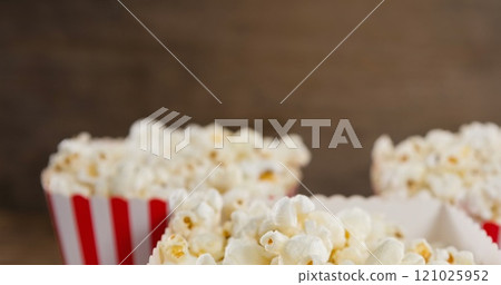 Image of boxes of popcorn over wooden table Image of boxes of popcorn over wooden table 121025952