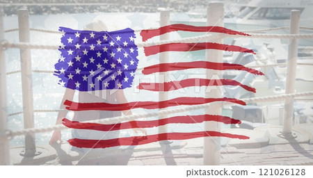 American flag design pattern against against rear view of woman sitting on a harbor 121026128