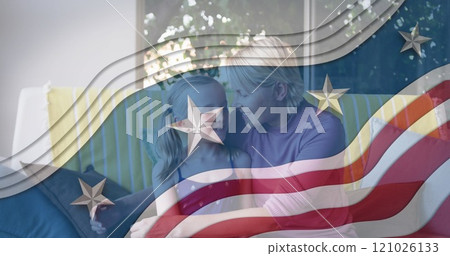 American flag design pattern against caucasian mother kissing her daughter at home 121026133
