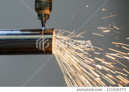 Close up scene the fiber laser cutting machine cut the stainless steel tube and sparkling light. Close up scene the fiber laser cutting machine cut the stainless steel tube and sparkling light. 121026373
