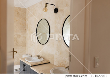 Modern bathroom with double sinks and round mirrors, elegant and clean design, at home Modern bathroom with double sinks and round mirrors, elegant and clean design, at home 121027012