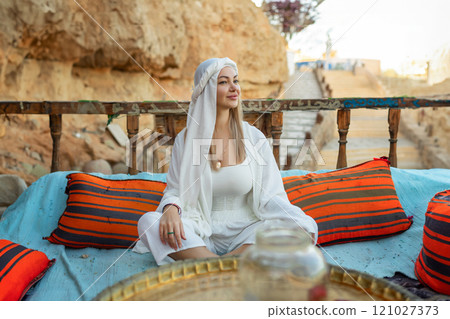 Portrait of a beautiful woman in Arabic clothing in Egypt during sunset. Portrait of a beautiful woman in Arabic clothing in Egypt during sunset. 121027373