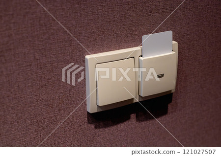 Hotel Room Card Power Switch on Textured Wall 121027507