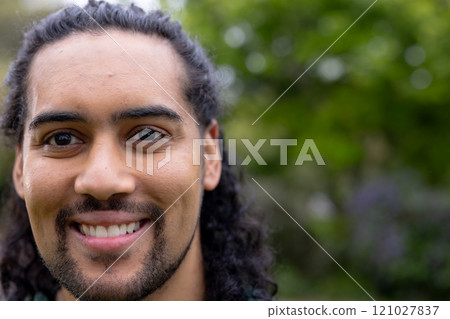 Smiling young man enjoying nature outdoors, feeling happy and relaxed, copy space 121027837