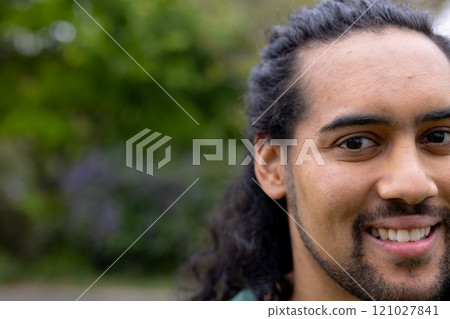 Smiling young man enjoying outdoor time with multiracial friends in park, copy space Smiling young man enjoying outdoor time with multiracial friends in park, copy space 121027841