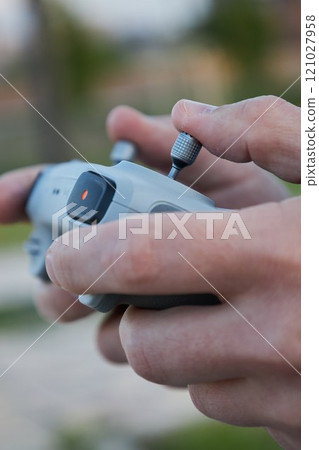 Male hands hold drone control panel. Management by quadcopter flight Male hands hold drone control panel. Management by quadcopter flight 121027958