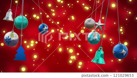 Image of christmas baubles over light spots on red background 121029653