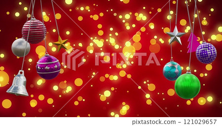 Image of christmas baubles over light spots on red background 121029657