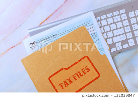 1040 tax form file computer keyboard on workspace suggest preparation for tax season financial planning. 121029847