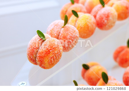 Colorful sweet fruit shaped desserts are elegantly arranged on vibrant peaches have sugary coating, inviting guests to indulge in delightful treat. Colorful sweet fruit shaped desserts are elegantly arranged on vibrant peaches have sugary coating, inviting guests to indulge in delightful treat. 121029868