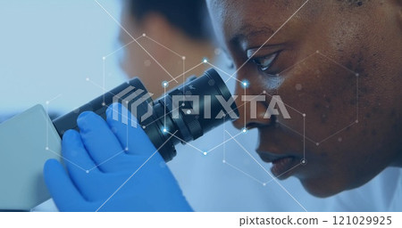 Image of network of connections over african american female scientist working in lab 121029925