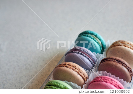 Bright colorful cakes French Macarons with white paperpan in plastic box 121030902