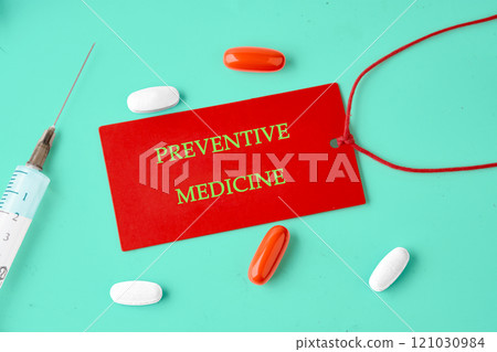Importance of preventive medicine highlighted with colorful pills and a syringe on a vibrant background Importance of preventive medicine highlighted with colorful pills and a syringe on a vibrant background 121030984