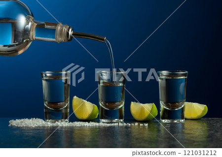 Tequila with lime and salt on a stone table. 121031212