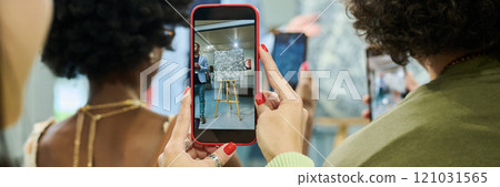 Gallery visitor holding smartphone Gallery visitor holding smartphone 121031565