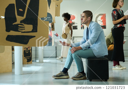 Sitting in front of creative exposition 121031723