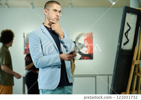 Man looking at artwork at exhibition 121031732