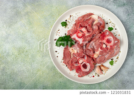 raw steak, calf's neck on the bone, fresh meat, on a white plate, top view, no people, raw steak, calf's neck on the bone, fresh meat, on a white plate, top view, no people, 121031831