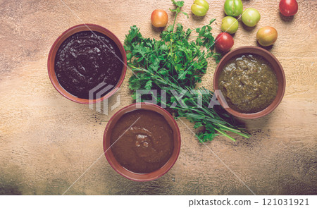 set of tkemali sauces, three types of tkemali sauce, in ceramic bowls, top view, Georgian cuisine, no people, 121031921