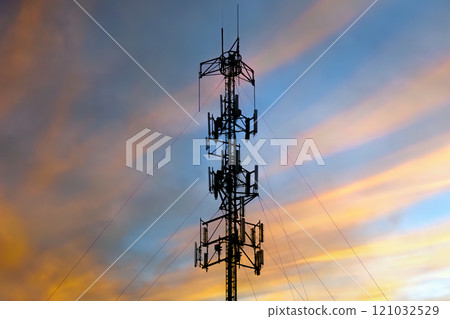 Cell Tower at Sunset with Vibrant Sky 121032529