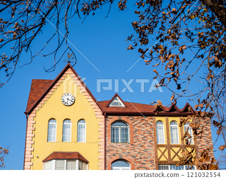 facade of urban house with wall clock in autumn facade of urban house with wall clock in autumn 121032554