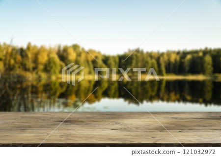 Wooden table with forest lake and nature background. Product display background. Wooden table with forest lake and nature background. Product display background. 121032972