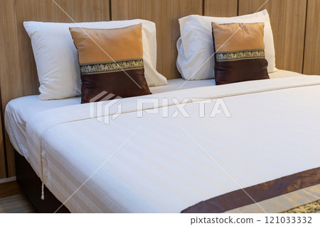 Luxurious and Cozy Bedroom Interior, Pillow with Unique Thai Patterns and Blanket on Bed Luxurious and Cozy Bedroom Interior, Pillow with Unique Thai Patterns and Blanket on Bed 121033332