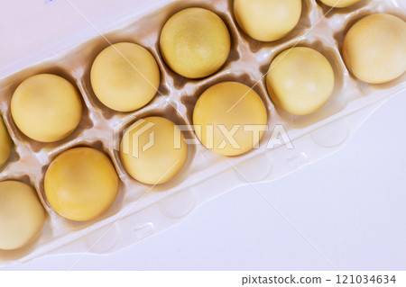 Dozen yellow eggs nestled neatly in egg carton ready to be used for cooking, baking Dozen yellow eggs nestled neatly in egg carton ready to be used for cooking, baking 121034634