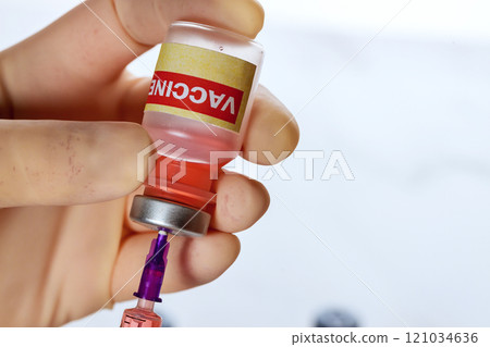 In process of filling syringe with vaccine, right dosage is ensured by filling syringe with vaccine for prevention used in fight against disease illness In process of filling syringe with vaccine, right dosage is ensured by filling syringe with vaccine for prevention used in fight against disease illness 121034636