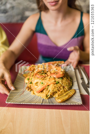 Arroz marinero ecuador, traditional cousine food, Portoviejo.Hispanic Unrecognizable persona hands 121035363