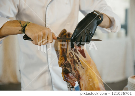 close up view of a professional ham cutter cutting ham and preparing portions 121036701