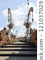 Editorial image of tourists exploring Panglipuran Village in Bali on November 9, 2024, beautifully adorned with penjor decorations for Galungan and Kuningan celebrations. 121037029