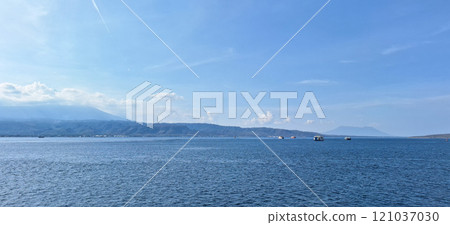 A serene view of the Bali Sea with calm blue waters and blue sky A serene view of the Bali Sea with calm blue waters and blue sky 121037030