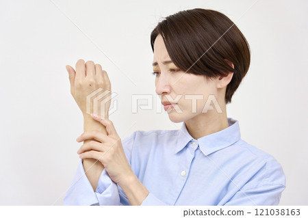 Woman with numb hands, white background 121038163