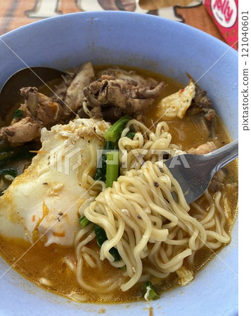 Home made noodle soup with chicken and vegetables in blue bowl. Home made noodle soup with chicken and vegetables in blue bowl. 121040601