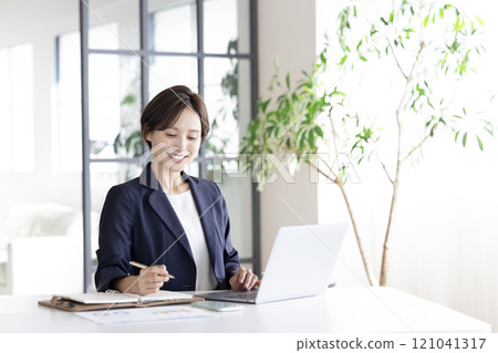Business: Businesswoman working on a laptop 121041317