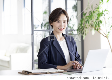Business: Businesswoman working on a laptop 121041319