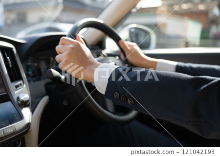 Male hands driving a car 121042193