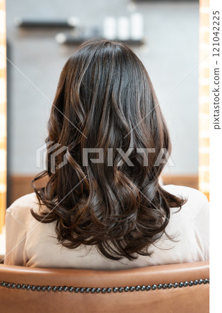 Woman with perm from behind Woman with perm from behind 121042225