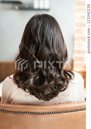 Woman with perm from behind 121042226