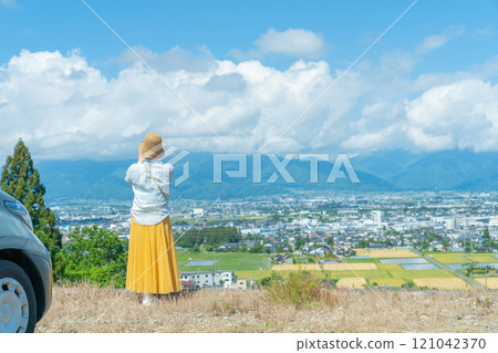 Photographed with a smartphone: A woman on a road trip in a car; Car and woman 121042370