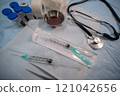 Sterile medical kit and syringe with stethoscope. Selective focus. High quality photo 121042656