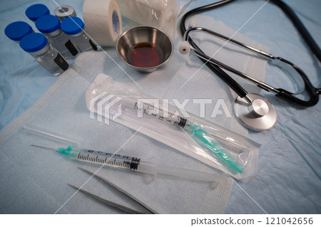 Sterile medical kit and syringe with stethoscope. Selective focus. High quality photo Sterile medical kit and syringe with stethoscope. Selective focus. High quality photo 121042656