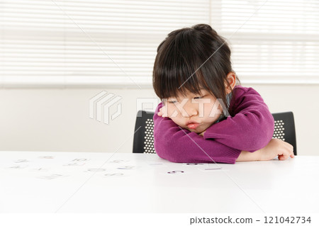 Unmotivated elementary school student. Image of poor study skills Unmotivated elementary school student. Image of poor study skills 121042734