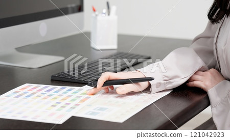 A creative woman working on a computer 121042923