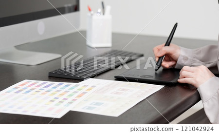 A creative woman working on a computer 121042924