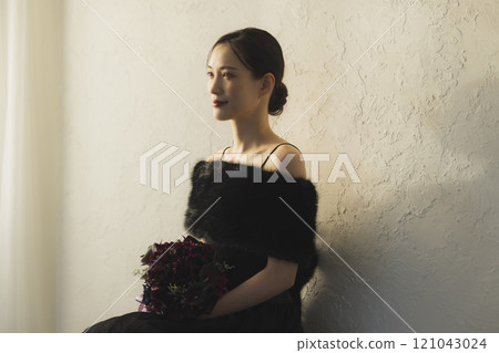 A woman in a black dress A woman in a black dress 121043024