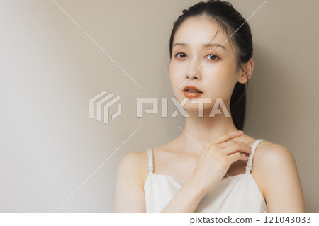 Woman smiling with hands on face Woman smiling with hands on face 121043033